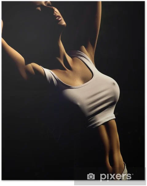 Young woman in a fitted white tank top, striking a pose against a dark background.